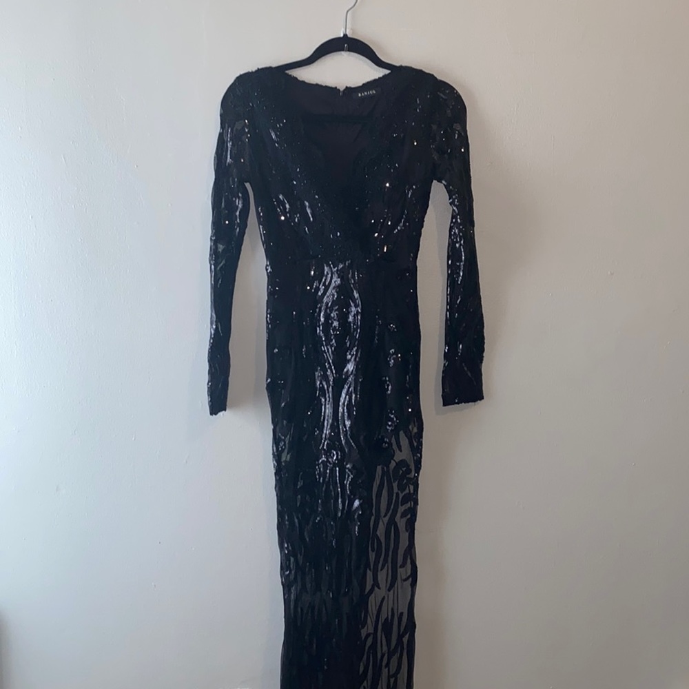 Black sequin dress, high slit on left side of dress.